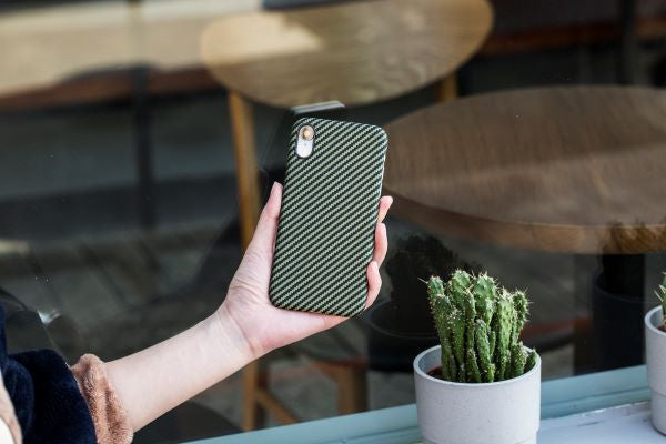 The black and yellow case on the blue iPhone Xs